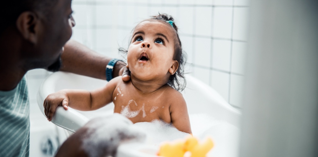dad giving child a bath